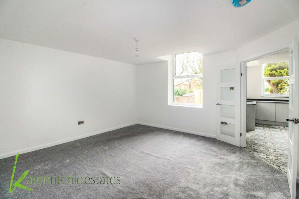 Completed family dining space with new kitchen beyond
